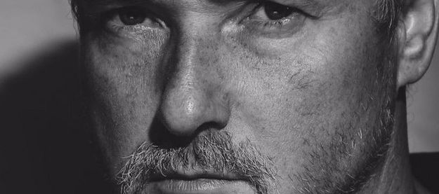 A greytone photo of a white man